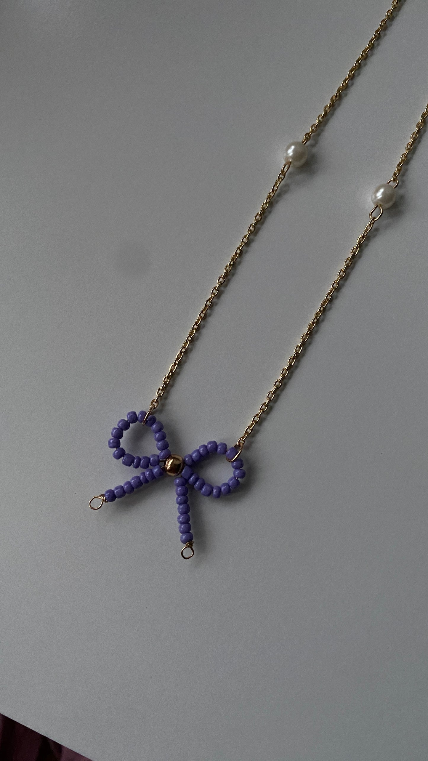 Beaded bow purple necklace ๐